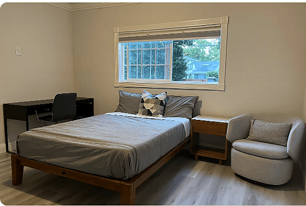 Pool room in daylight, queen bed and desk
