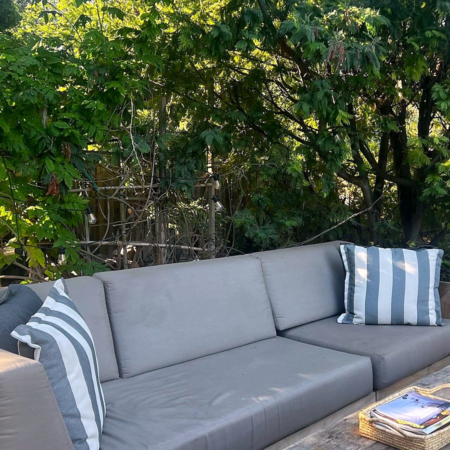 The grey sofa and coffee table on the deck
