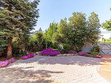 The paved court with flower beds