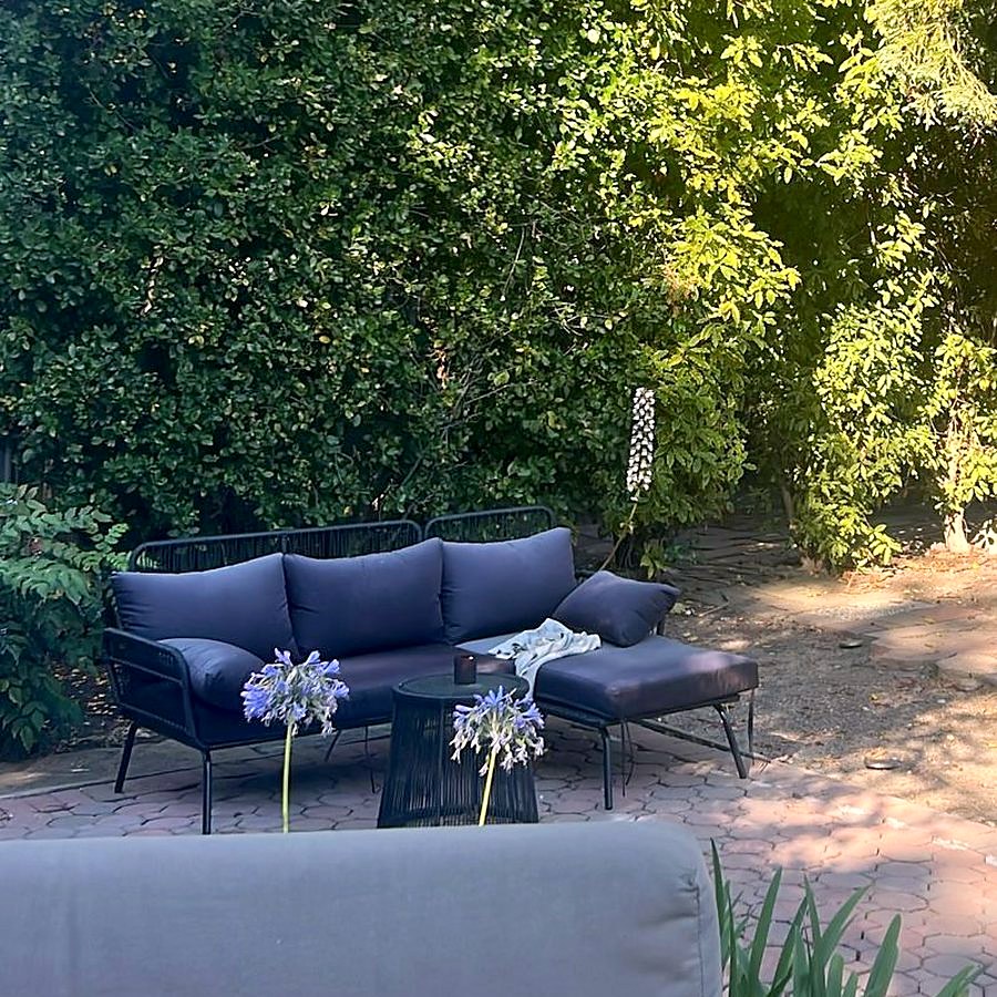 A sofa in the garden, under the trees