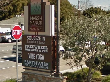 The neighbourhood centre sign: breakfast, a pub, yoga